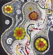 Wedding on two continents Indian and continental wedding symbolism on slate. The inspiration for this piece comes from my two cultures and draws on the diversities and commonalitiesassociated with weddings on all continents. Use of bangles, marigold flowers the colour red , yellow and white, rice, shells and walking on a path are conceptualised in this piece which is created on slate